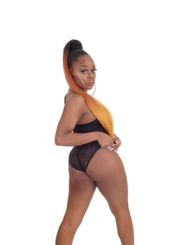 A lovely young African American woman standing in a black body suit,.smiling, isolated for white background.