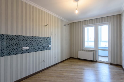 The interior of the renovated empty kitchen without furniture