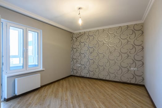 The interior of an empty, freshly renovated room in a new building without furniture