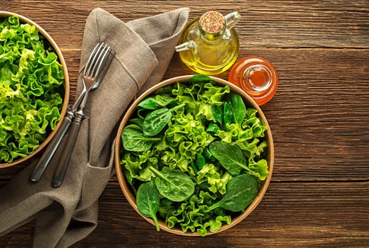 Healthy green salad on wooden table background. Healthy meal.