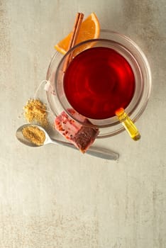 Cup of fruit tea with sugar on grey table background