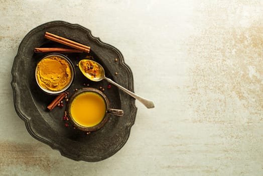 Healthy drink made from turmeric roots, spices, milk and honey. Golden Milk, made with turmeric and other spices