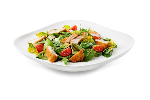 Healthy green salad with crispy fried breaded chicken breast strips and tomatoes isolated on white background