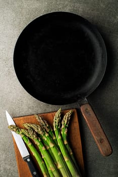 Fresh of green Asparagus. Cooking healthy meal in pan. Bunches of green asparagus, top view- Image