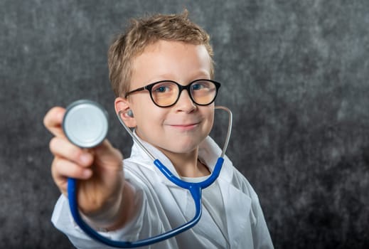 Cute kid boy wear medical uniform playing doctor, a portrait
