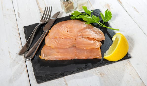 Delicious raw salmon fish fillets on the white wooden
