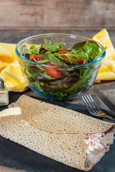 Breton crepe with cheese and bacon on the wooden background