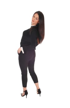 Beautiful slim young woman standing in the studio from the back,.looking over shoulder, bending back, isolated for white background.
