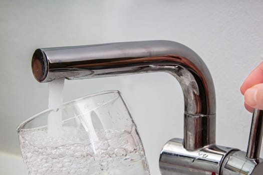 Glass at water tap and filling water with lead contamination