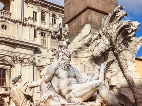 a seagull resting on the head of the statue representing the Ganges river in the Fountain of the four rivers in Piazza Navona in Rome. Travel and famous destinations