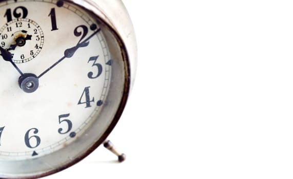 detail of an old analog alarm clock isolated on a white background