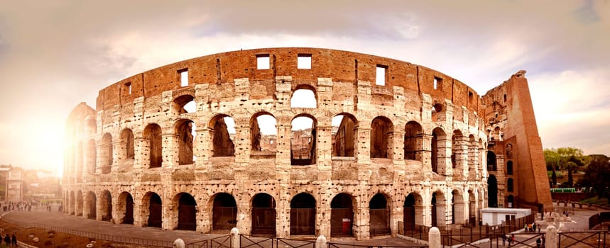 the Colosseum of Rome seen from behind at sunset. Ancient Roman civilization.