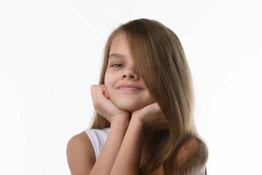 Portrait of a close-up of a girl covering part of her face with her hair