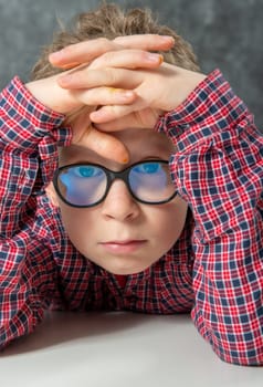 portrait of pensive cute child with a checkered shirt