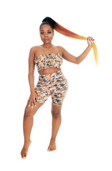 A lovely young African woman standing in a beach outfit in the studio.from the front, isolated for white background.