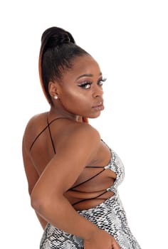 A lovely young African American woman standing from the back in.an gray dress, looking over shoulder, isolated for white background.