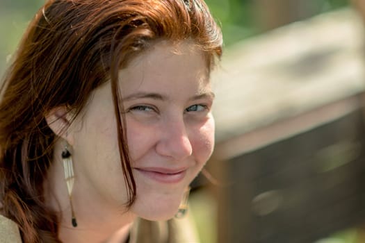Portrait of a laughing young girl with dark hair against blurred background