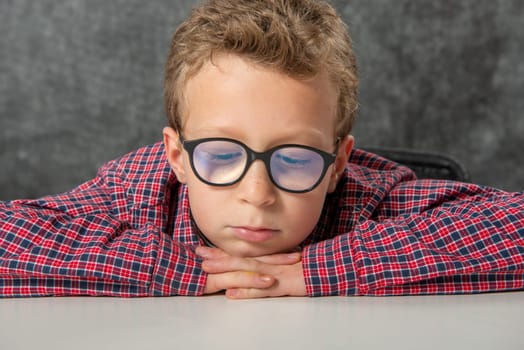 portrait of pensive cute child with a checkered shirt