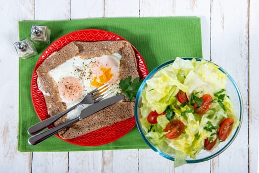 homemade Breton crepe with egg and a green salad
