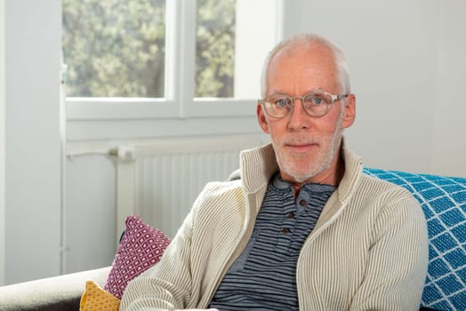 portrait of senior with white hairs wearing eyeglasses