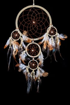 Pearl-embroidered dream catcher with colorful feathers and pearls against a black background