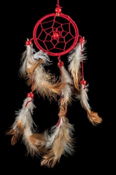 Pearl-embroidered dream catcher with colorful feathers and pearls against a black background