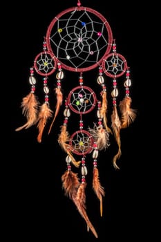 Pearl-embroidered dream catcher with colorful feathers and pearls against a black background