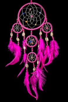 Pearl-embroidered dream catcher with colorful feathers and pearls against a black background