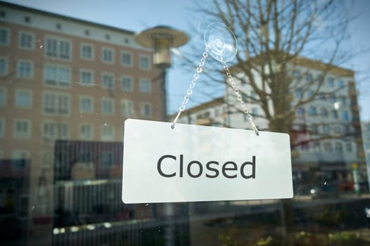 Sign with the inscription "closed"" on the window of a shop"