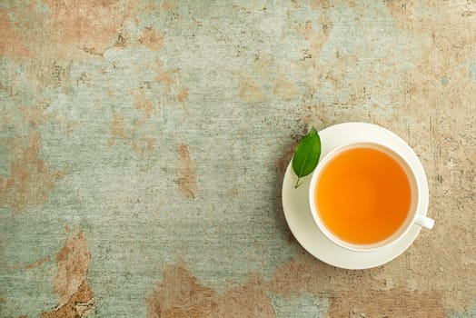 Tea cup. Cup of green and herbs tea served with fresh leaf