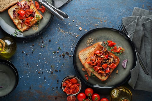 Breakfast served with toast sandwiches with tomato, onion and herbs. Bruschetta with roasted tomatoes. Continental delicious healthy breakfast table