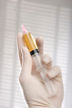 Coronavirus concept. Injection with vaccine in a glass tube close up shoot.