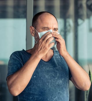 Man wearing facial disposable mask to avoid viral infection. Virus protection