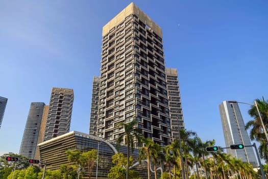 High-rise buildings in the city in clear sunny weather with tropical greens, Shenzhen, China, Asia