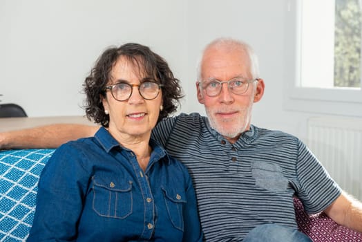 Senior couple relaxing on a sofa at home