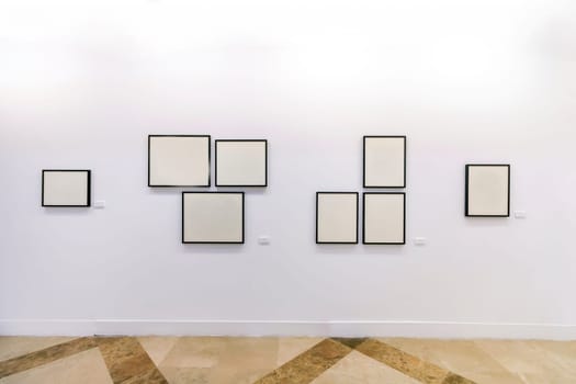 Close view of a bunch of empty blank frames on museum exhibition.