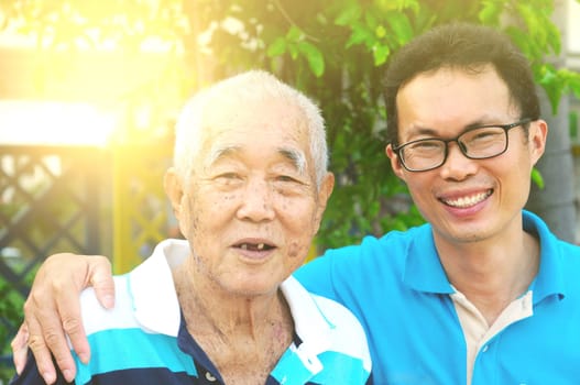Happy asian family relaxing in the garden.Senior man smiling.
