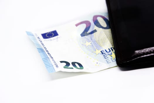 a 20 euro banknote comes out of a leather wallet isolated on a white background. Finance and politics. Current currency in the European Union