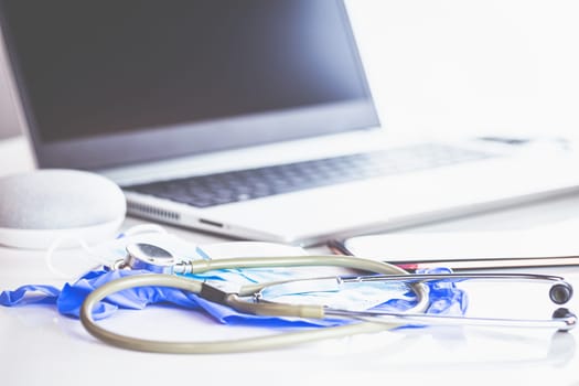 Home Office Medicine - PC with mask, stethoscope for protection against virus, infection, diagnosis and documentation.