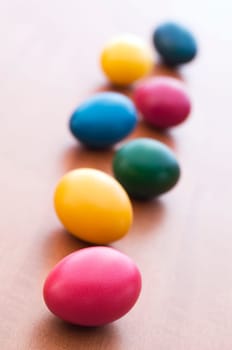 Colorful Easter eggs on wooden table background close up