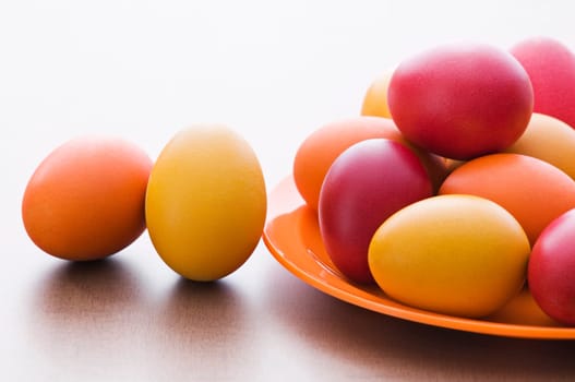 Colorful Easter eggs on wooden table background close up