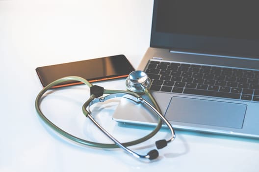 Home Office Medicine - PC with mask, stethoscope for protection against virus, infection, diagnosis and documentation.