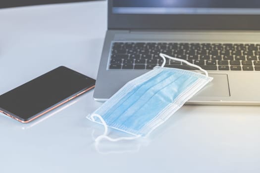 Home Office Medicine - PC with mask, stethoscope for protection against virus, infection, diagnosis and documentation.