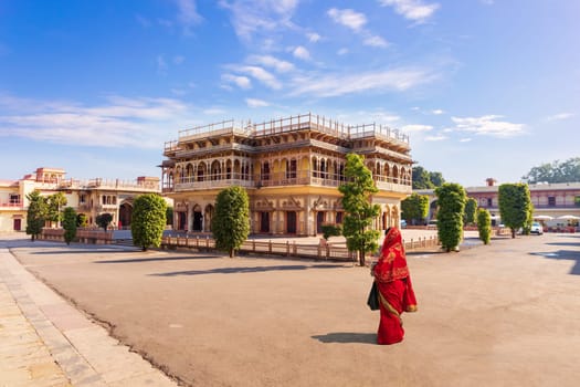 Jaipur City Palace and Indian girl in sari, India.