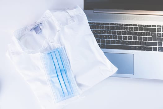 Home Office Medicine - PC with mask, stethoscope for protection against virus, infection, diagnosis and documentation.