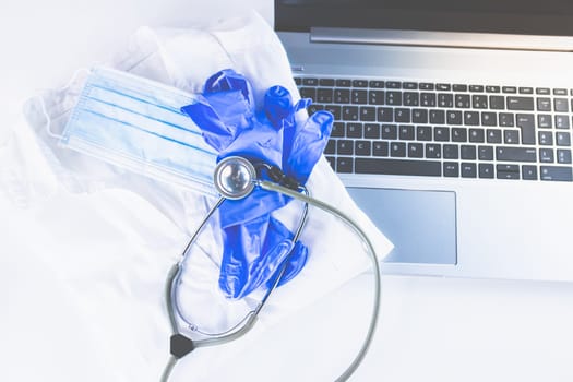 Home Office Medicine - PC with mask, stethoscope for protection against virus, infection, diagnosis and documentation.