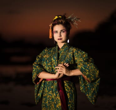 Fine art portrait of european woman in Japanese Geisha style wearing kimono