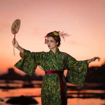 Fine art portrait of european woman in Japanese Geisha style wearing kimono