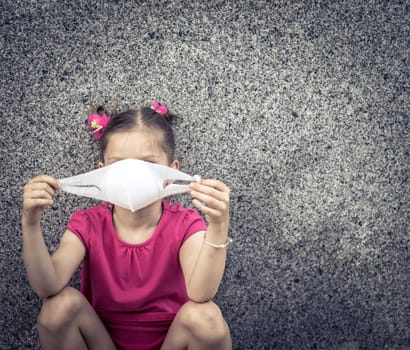 Girl wearing facial disposable mask to avoid viral infection. Virus protection