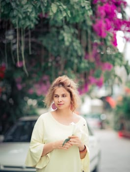 Outdoor portrait of a beautiful woman with flower